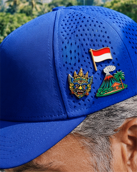 Blue cap with Indonesian flag, Barong mask and volcano pins, for the Jakarta office