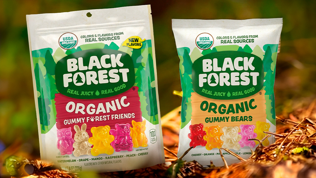 Black Forest organic Gummy Bears and Gummy Forest Friends bags on a forest floor