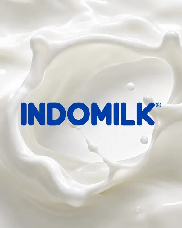 Blue Indomilk logo on a milk splash