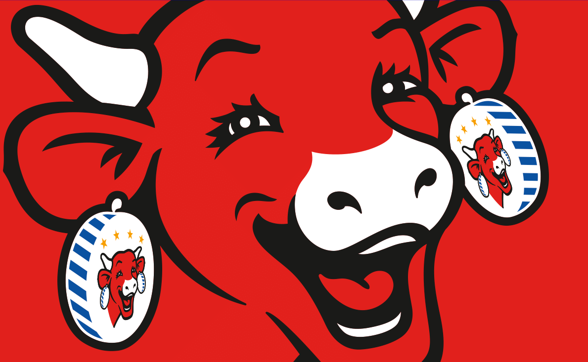 The Laughing Cow: smiling red cow head wearing its earrings, red background